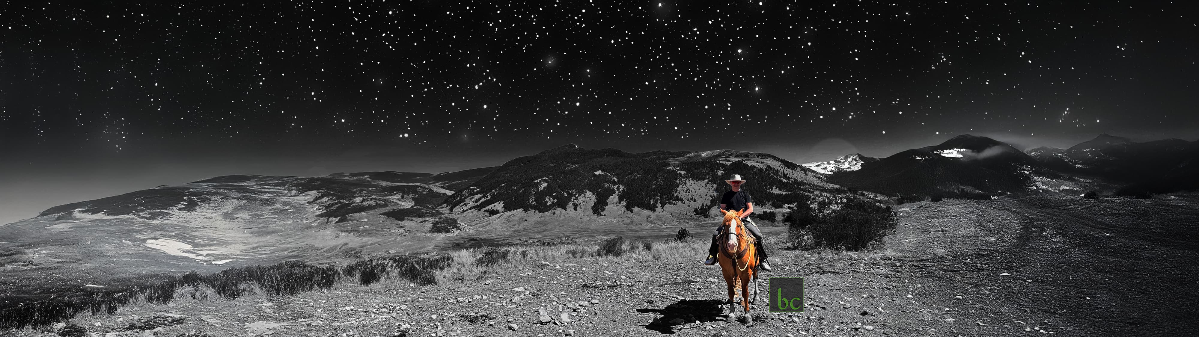 bc on horseback in a mountain landscape under a dark sky.